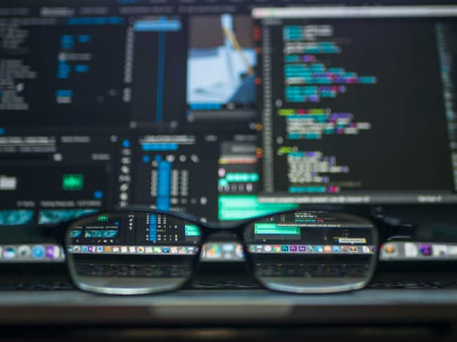 Photo of computer screen with a glasses providing the focus